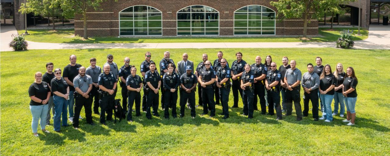 A group of officers and civilians pose for a photo